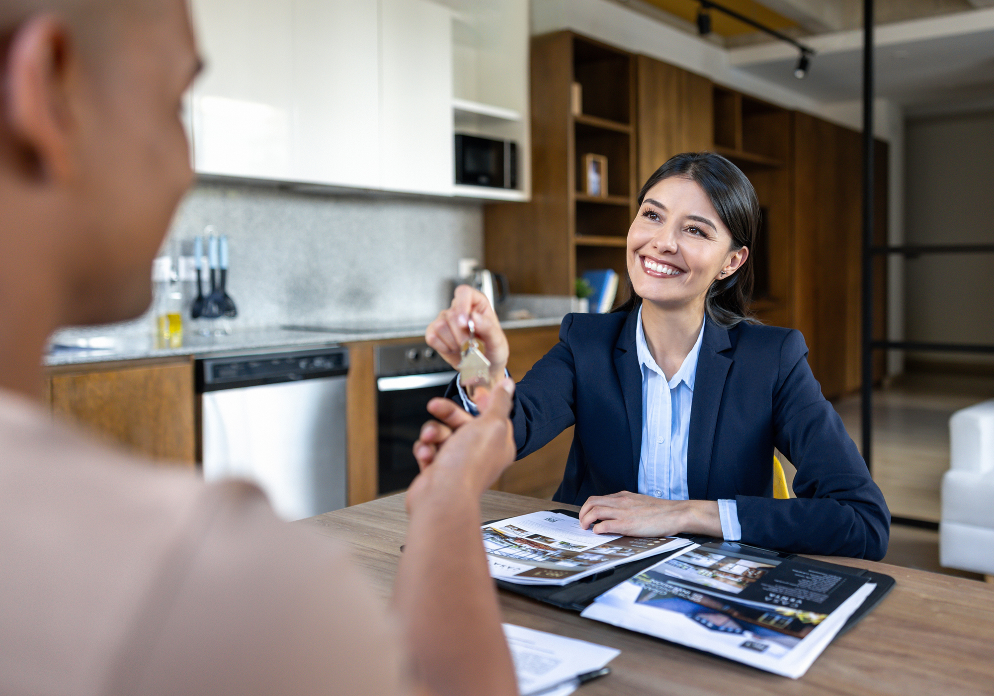 Real estate agent handing keys to client