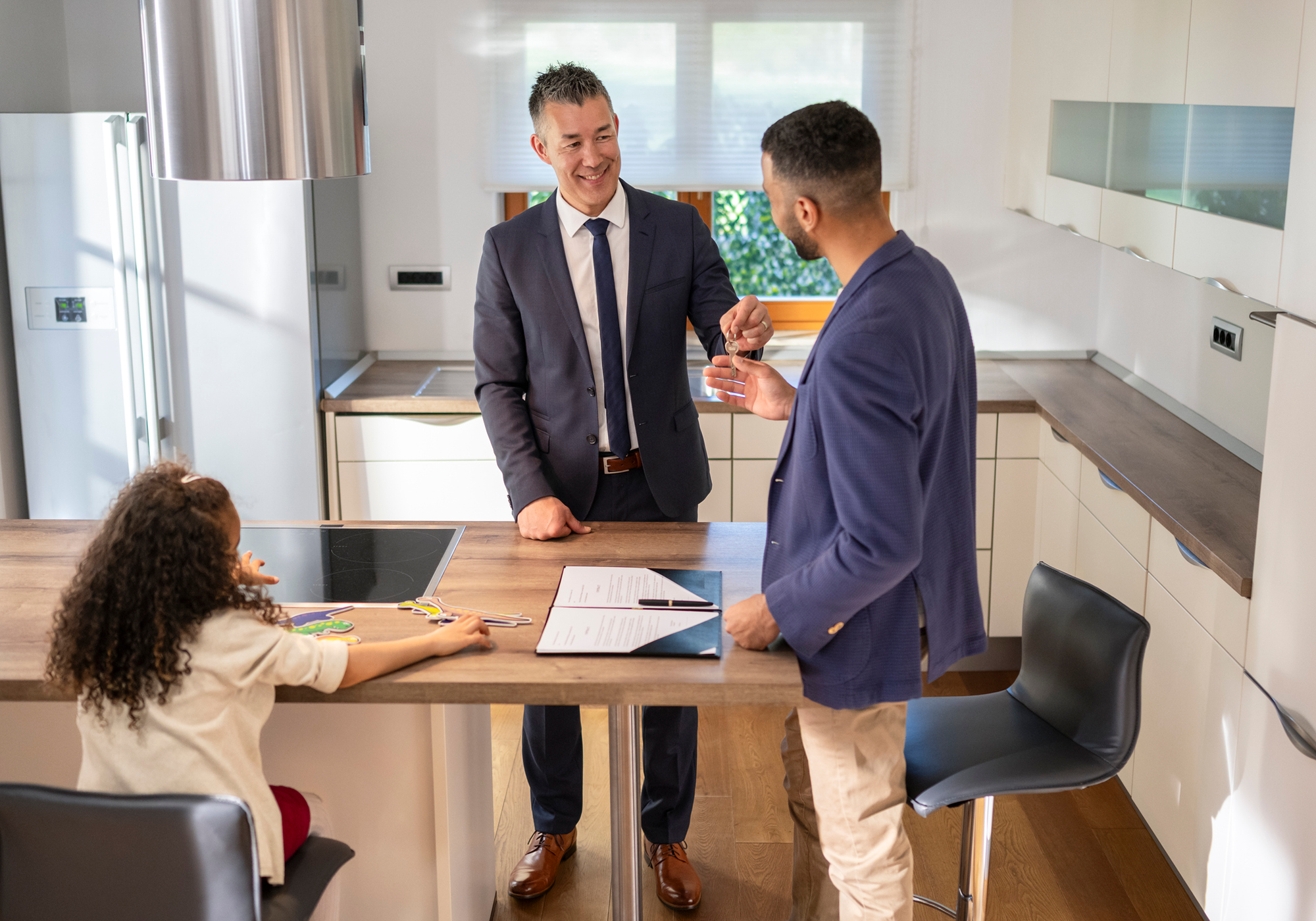 Man showing kitchen to potential buyers