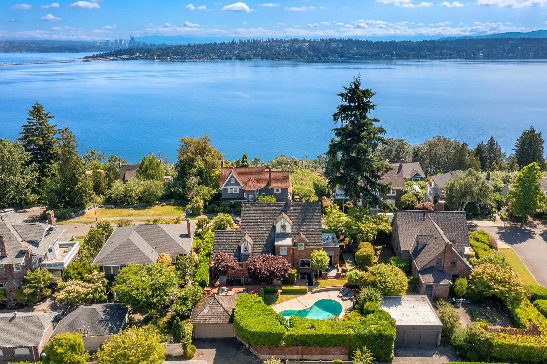 Aerial view of waterfront neighborhood with pool