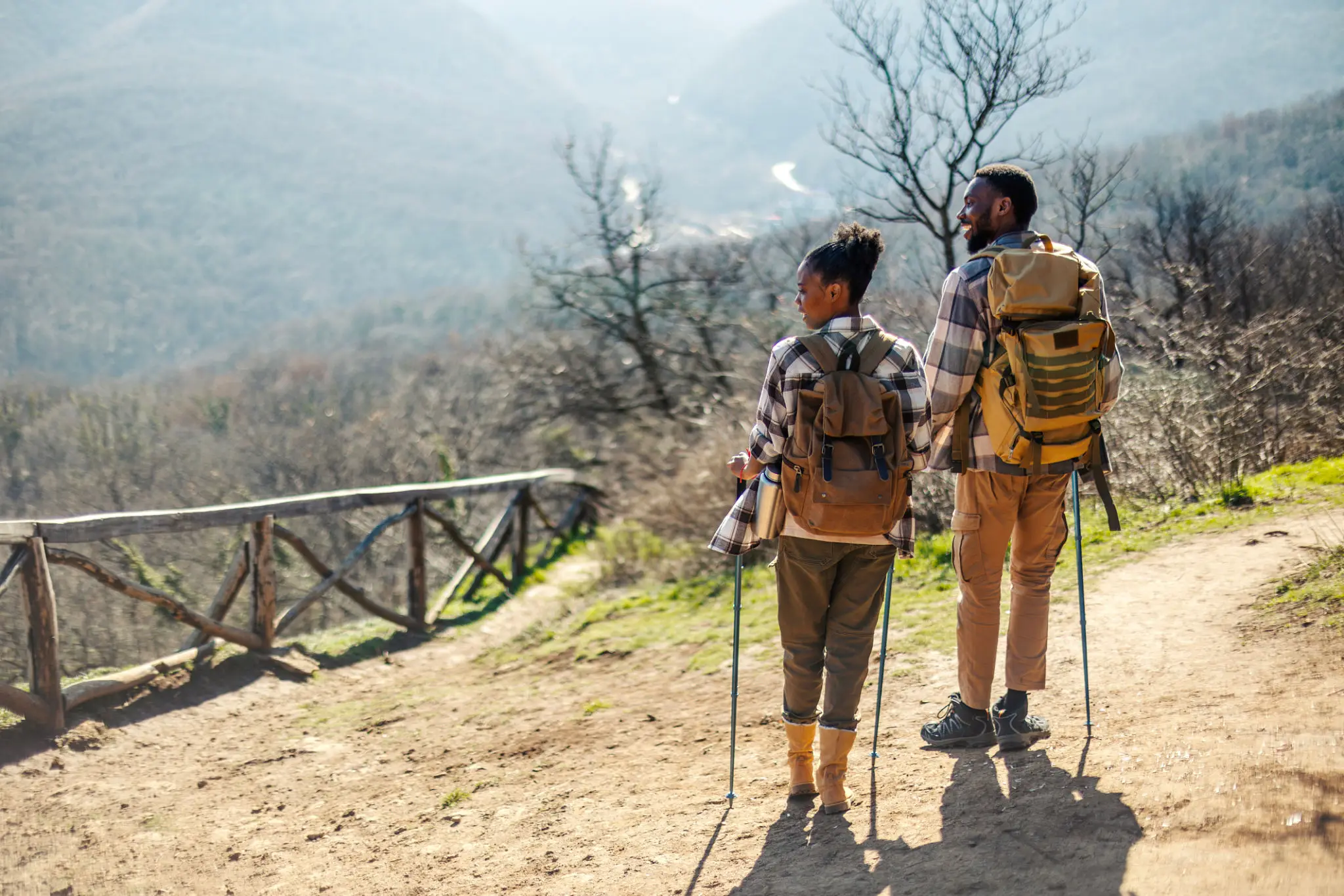 Two hikers with backpacks and trekking poles